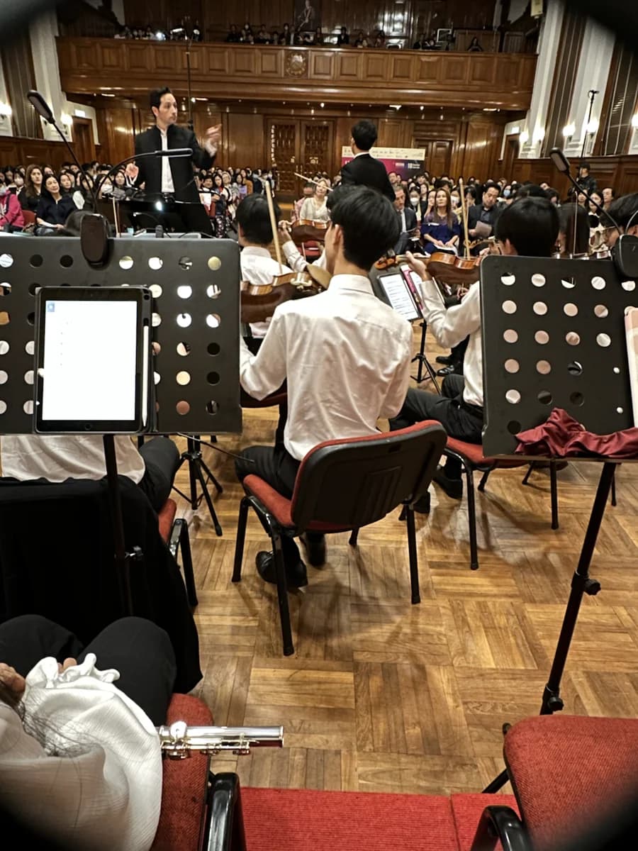 A view through the music stands toward the conductor at HKU